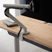 Monitor arm mounted on the desktop edge