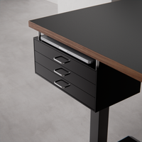 Black drawer close-up with laptop in the bracket gap