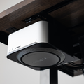 Mount for Mac Studio in Black, mounted under a desk top