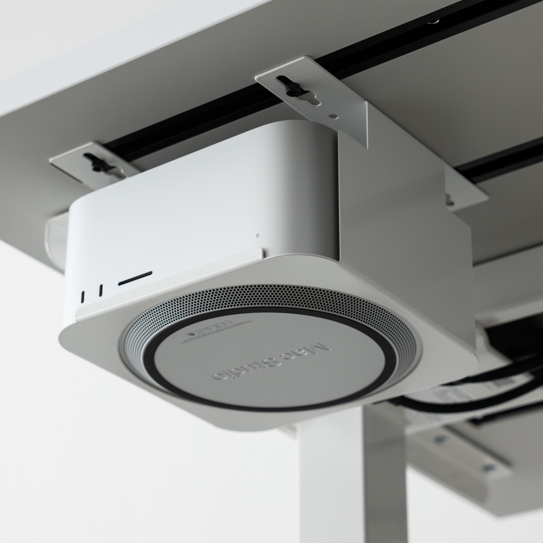 Mount for Mac Studio in White, mounted under a desk top