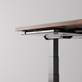Black desk tray mounted under a desk