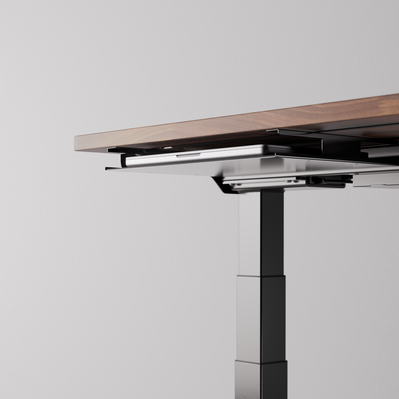 Black desk tray mounted under a desk